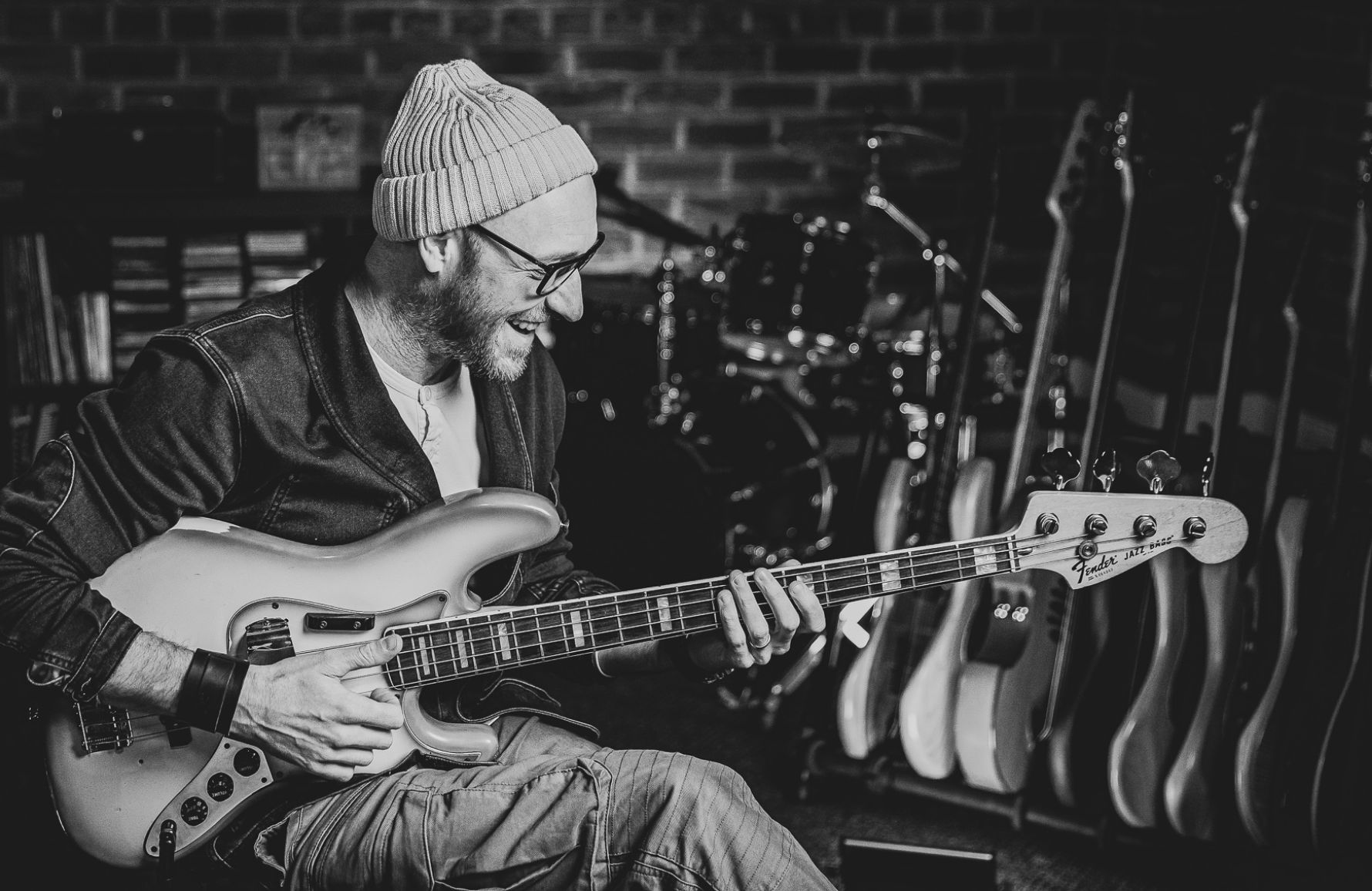 Scott smiling while playing bass